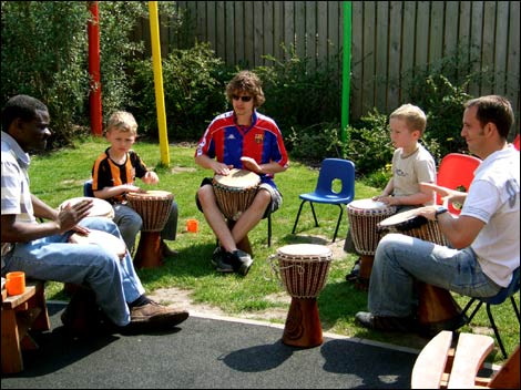 Children and fathers playing drums 470