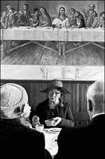 Members of a chapel congregation sitting under a picture of The Last Supper