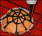 Picture: Use the black icing to make spider web