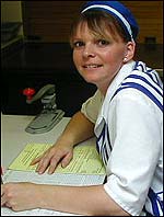 Picture: Wendy in her cook's uniforn at a desk.