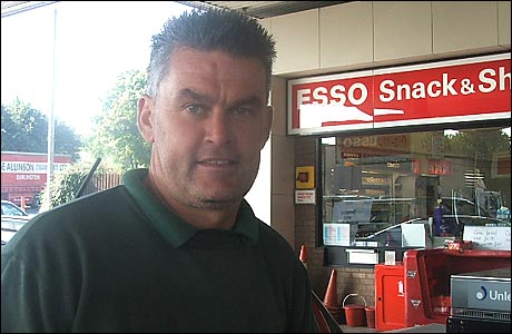 A motorists fill his car with petrol