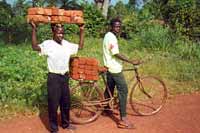 Children delivering hand-made bricks for their new school