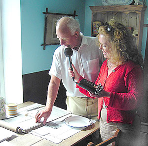 Sam and Marie look at the papers on the table