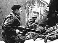 Soldiers dive for cover as Provisional IRA gunmen open fire in the Lenadoon estate
