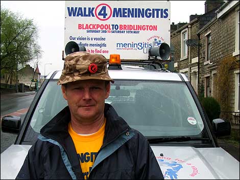 Man standing infront of a car 470