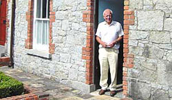 Sam Hanna in the doorway of No.6 College Square