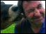 Cow licking a man's ear