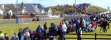 Spectators line the 7.5 mile track
