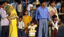 Indian family in Calcutta, India Indian family in brightly-coloured clothing standing on a busy roadside