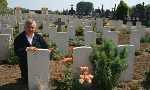 Eamonn Holmes at his great uncle Hugh Fitzsimmons's grave in Estaires, France
