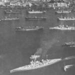 HMS Rajah is seen here off the stern, starboard quarter of  the Battleship HMS King George V. The photograph was taken by one of the Rajah's aircraft while anchored in Colombo Harbour. (Photograph, Crown copyright).