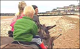 Pic: Children riding donkeys on beach.