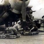 HMS Implacable, aircraft carrier (possibly 1945).  Crew loading an Avenger plane with smoke bombs for practice attacks on the fleet.