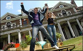 Picture: Jake and Holly jumping for joy outside the Fame Academy