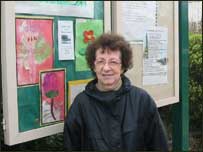 Campaigner Doris poses in front of the Handforth Community noticeboard