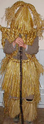 Fermanagh mummer complete with a three pronged straw pleated hat, straw jacket and straw skirt