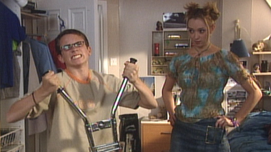 Michael tests his muscles in front of Abi