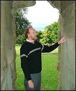 Archaeologist John Hemingway looking at the mortar joints in the Priory