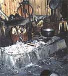 Image of man using ember and tinder to create a flame