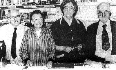 George, Isobel Graham, Nancy McFaul,and Llewellyn behind the counter in the newsagency.