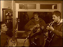 The Midbeats play guitar in the kitchen