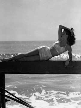 Ava Gardner lounges in the California sunshine in an elasticated spandex two-piece from 1943, photo courtesy of Getty Images/Eric Carpenter/John Kobal Foundation.