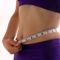 A woman measuring her waist
