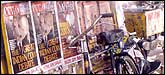 India Today Bike: A Newspaper seller's bike parked near a wall adorned with India Today posters. Shot at Saket, Delhi.