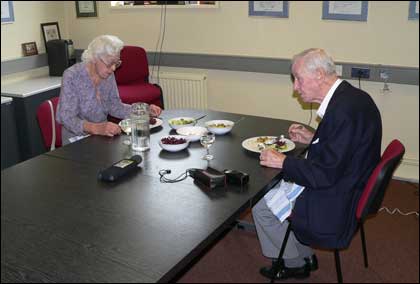 Two pensioners enjoty a meal