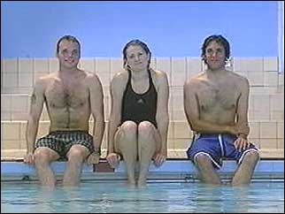 Three successful swimmers on the pool edge
