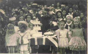 'Old Mother Rielly and Kitty' Terry Darlow right foreground with dog Floss at VE Day street party