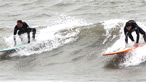 Two surfers on the same wave. Image by Mark Evans