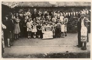 D'Eynsford Road, Camberwell VE Day street party. My three sisters and cousin, who were evacuated to Warrington, are here. I am on the left - next to the boy with the buttonhole