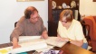 May Grant looks at the diary with Bruce Drurie.