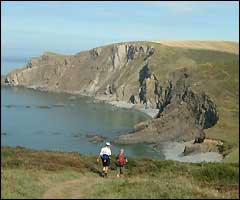 Jo walking along the coasr path