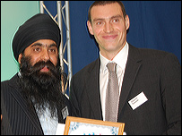 Karnjit Khatkar receives the Unsung Sporting Hero award from Derby County goalkeeper Stephen Bywater