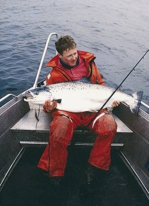 Jesper Fohrmann with his salmon caught by trolling a dead herring – it took 50 minutes to bring aboard