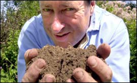 Alan Titchmarsh holding some soil
