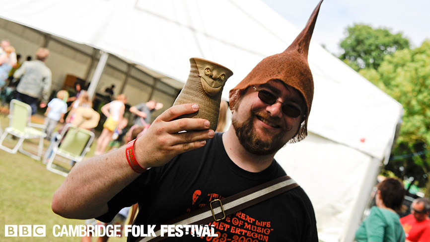 A punter arrives at the festival, mug in hand.