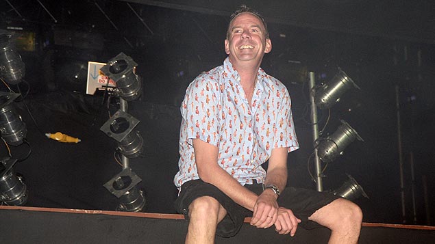 Fatboy Slim bounces down to the edge of the stage to kick his legs and tease the crowd.