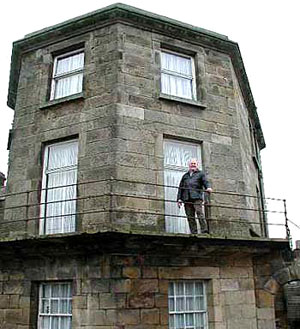 Alan Dodds stands on the balcony of the prison governor's house.