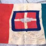 The Italian flag captured in Libya on November 21st 1942 by a detachment of the 8th Army and signed by them. George Cosmo McCallam won the lot to keep the flag. The Italian flag captured in Libya on November 21st 1942 by a detachment of the 8th Army and signed by them. George Cosmo McCallam won the lot to keep the flag.