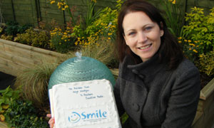 Southern Counties Radio's Sara David with celebratory cake from the Rainbow Trust