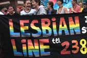 Image of a lesbian line banner being carried in Belfast's Gay Pride Parade