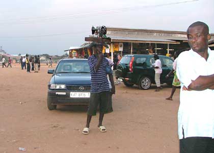 Man with sewing machine on his head