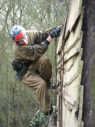 Matt Fincham climbing down a wall
