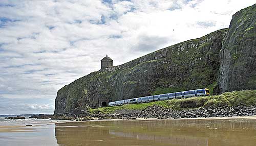 A Derry-bound train emerges from the tunnels at Downhill on Northern Ireland’s scenic railway