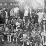 A concert audience in the garden, Rotherham 1940's.  Audrey holds her baby sister.(On the right)