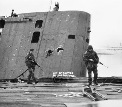 Royal Marine patrol passing the submerged fin of the Sante Fe at South Georgia
