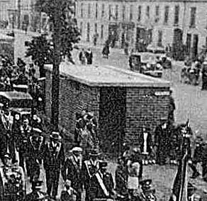 Orangemen marching past an air raid shelter